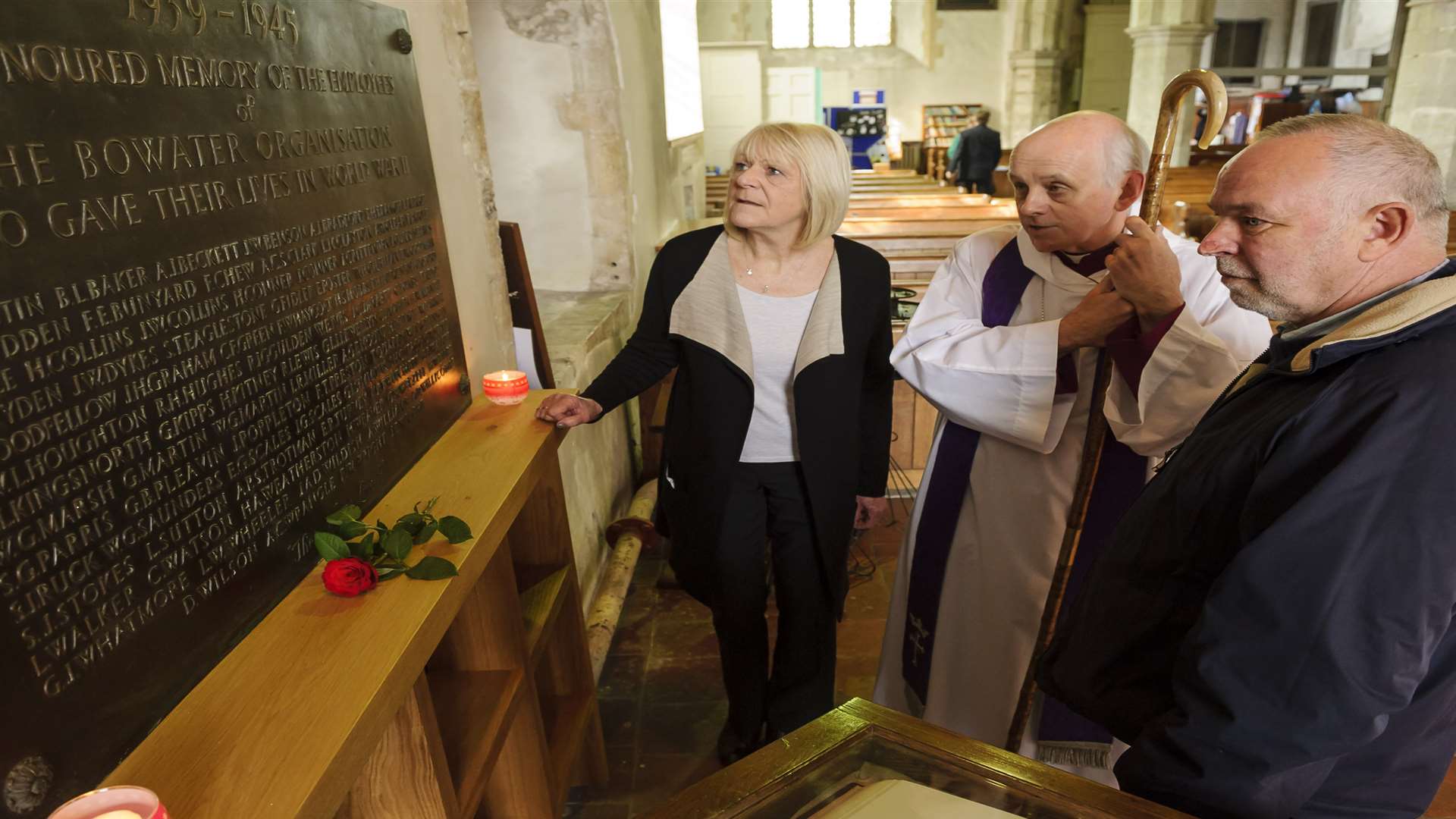 Jan Rainer, left, and Chris Andrews, right, who were instrumental in getting the plaque dedicated, with Bishop Trevor, reading the plaque.