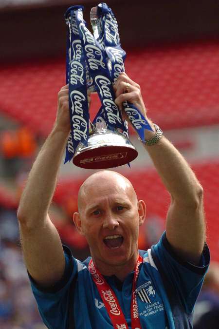 Mark Stimson hold the play-off winners' trophy aloft