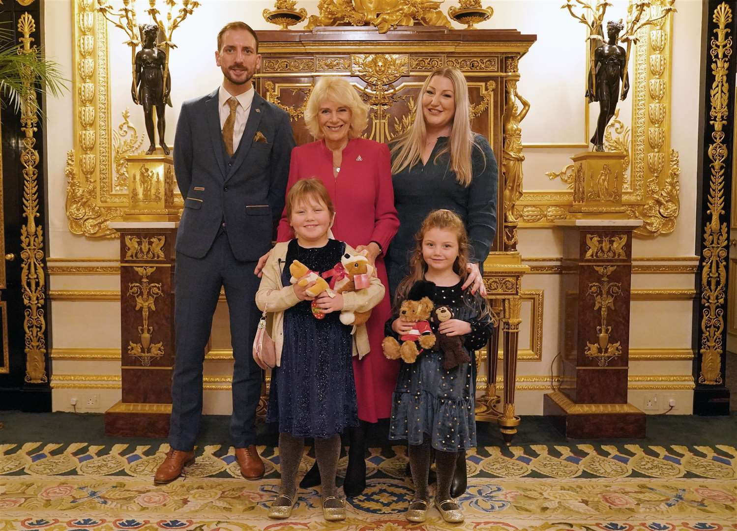 Olivia and her family posing for a picture with Camilla (Jonathan Brady/PA)