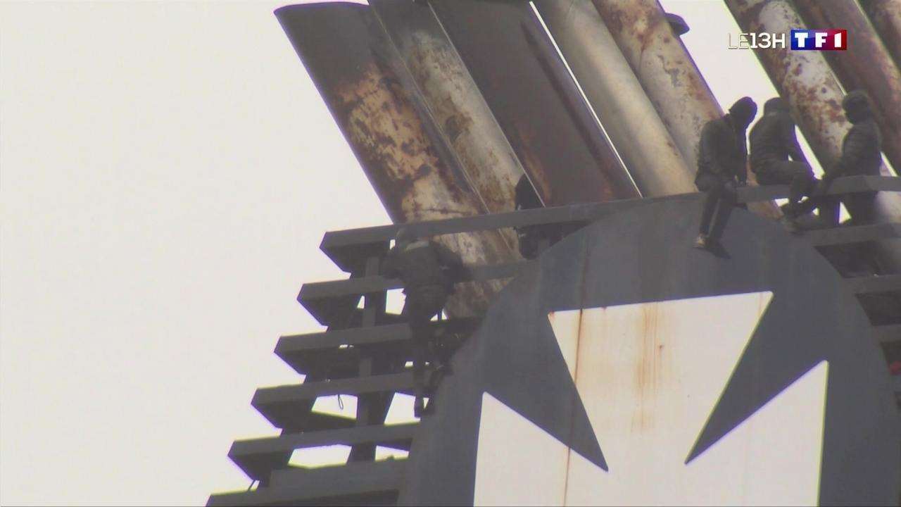 Migrants clamber onto the ship's funnel. Picture: TF1