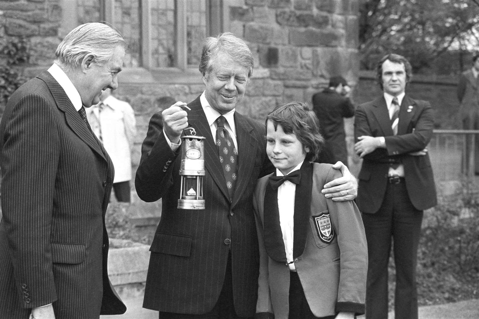 Ian McEree, 12, presents an old miner’s lamp to US President Jimmy Carter on behalf of Washington village (Archive/PA)