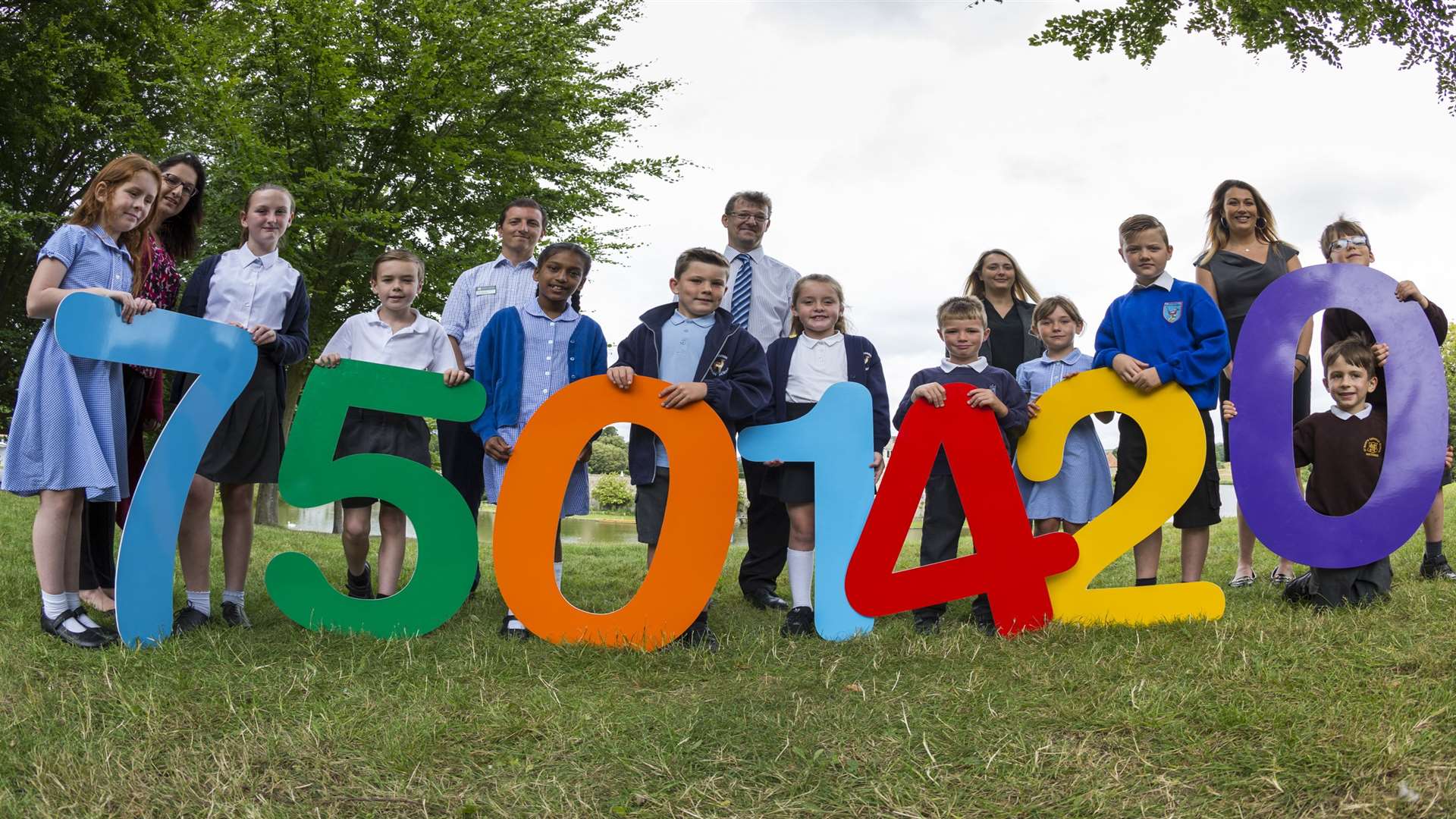 Leading participants of Buster's Book Club and key supporters announce the record reading figure for 2017 at Leeds Castle, Maidstone.