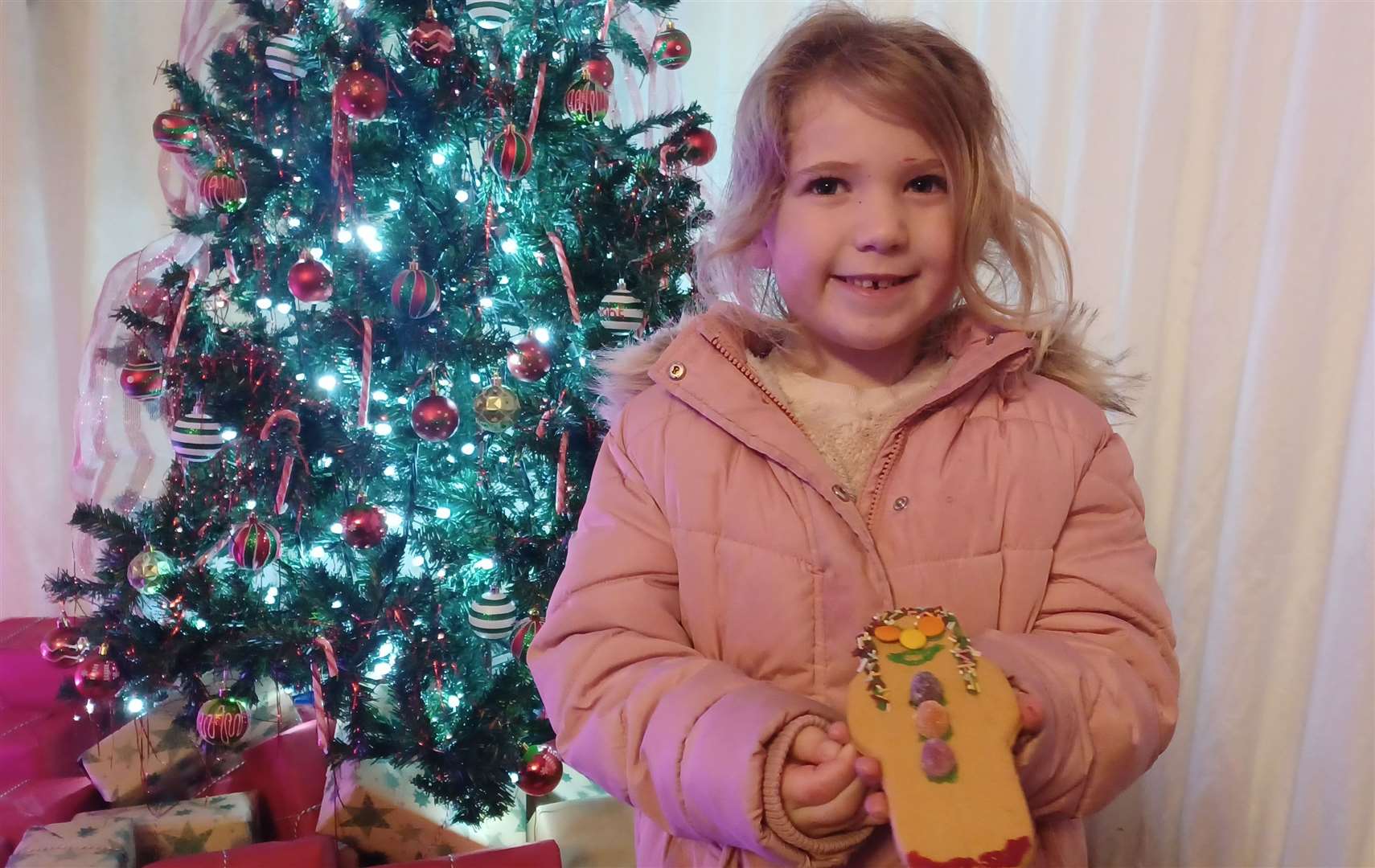 Showing off her decorated biscuit