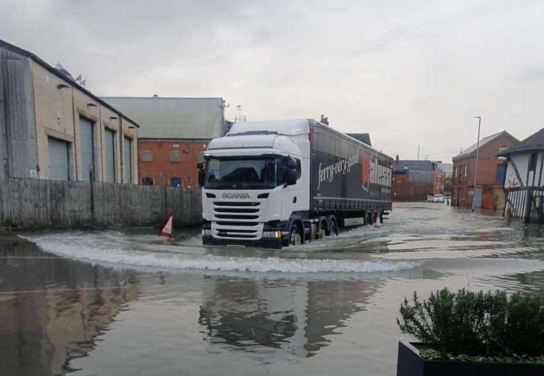 A lorry causes waves as it heads through the Faversham floods. Picture: The Quay