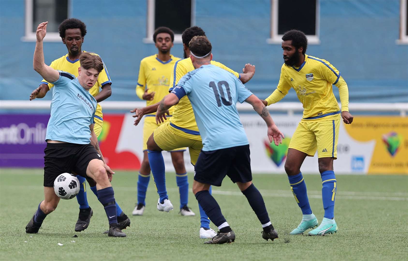 Dover Rangers FC (Blue) battle for the ball in midfield against Streatham FC (Yellow & blue). Picture: PSP Images