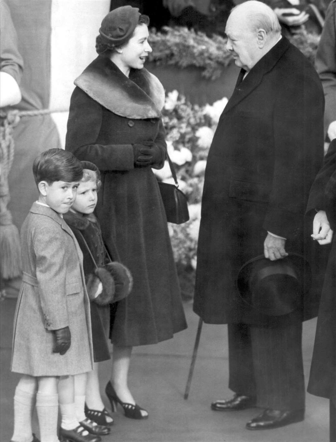Queen Elizabeth II chats to Sir Winston Churchill while awaiting the arrival of the Queen Mother at Waterloo Station on her return from visiting Canada and America.24th November 1954 Picture: TopFoto
