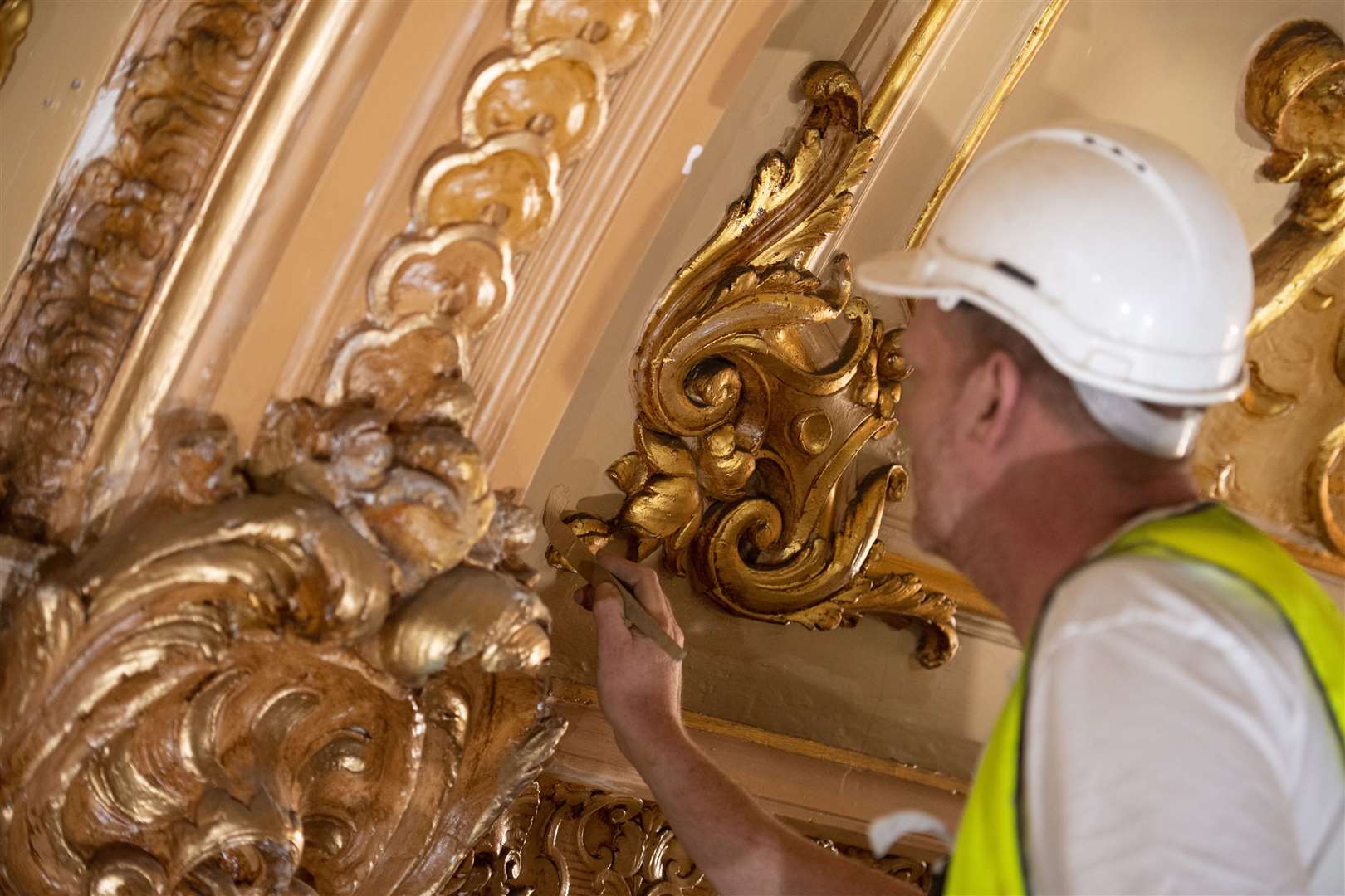 A specialist painter during the restoration of the Blackpool Tower Ballroom (Oli Scarff/Blackpool Tower/PA)