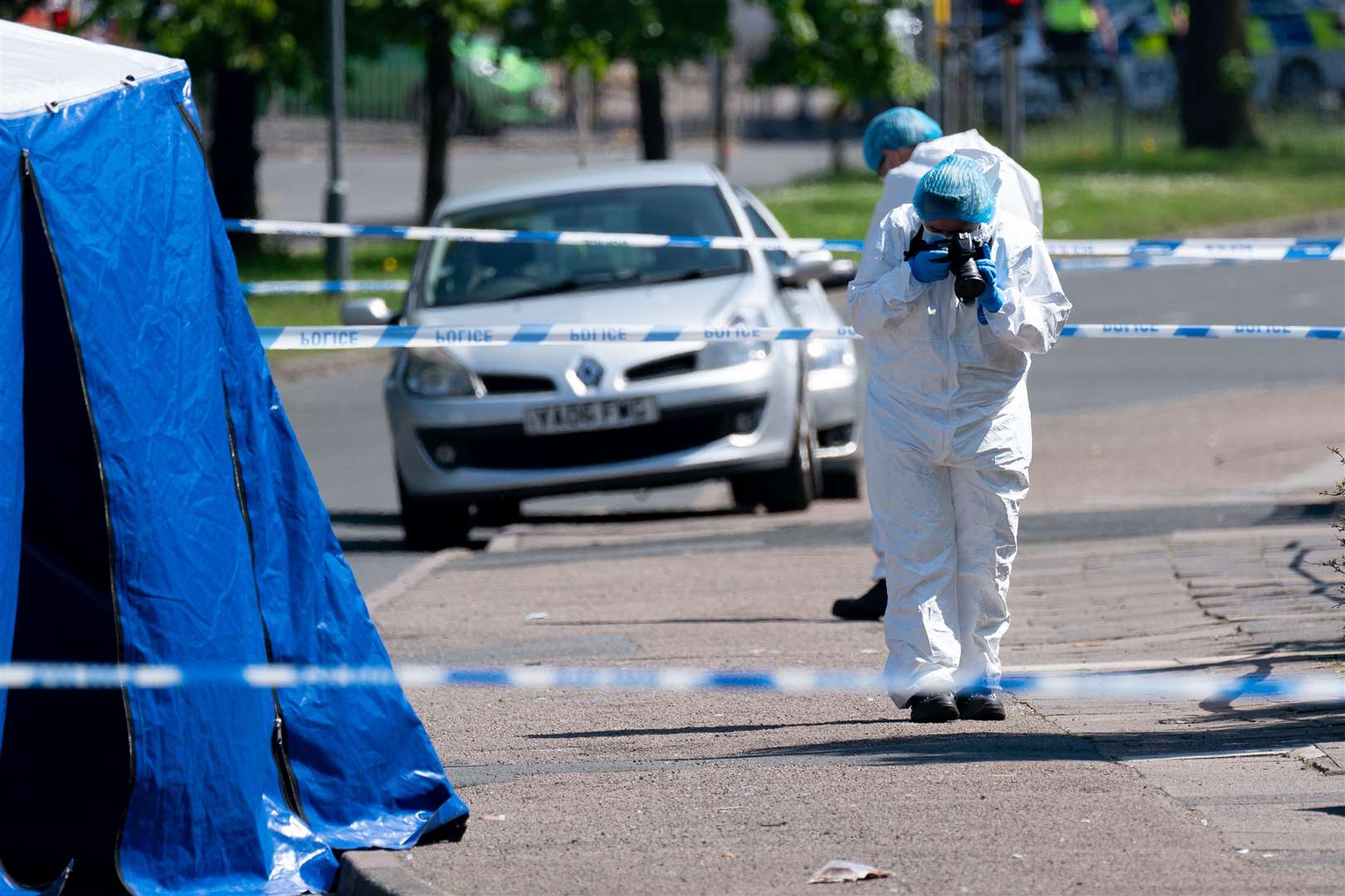 A forensics officer at the scene on College Road, Kingstanding (Jacob King/PA)