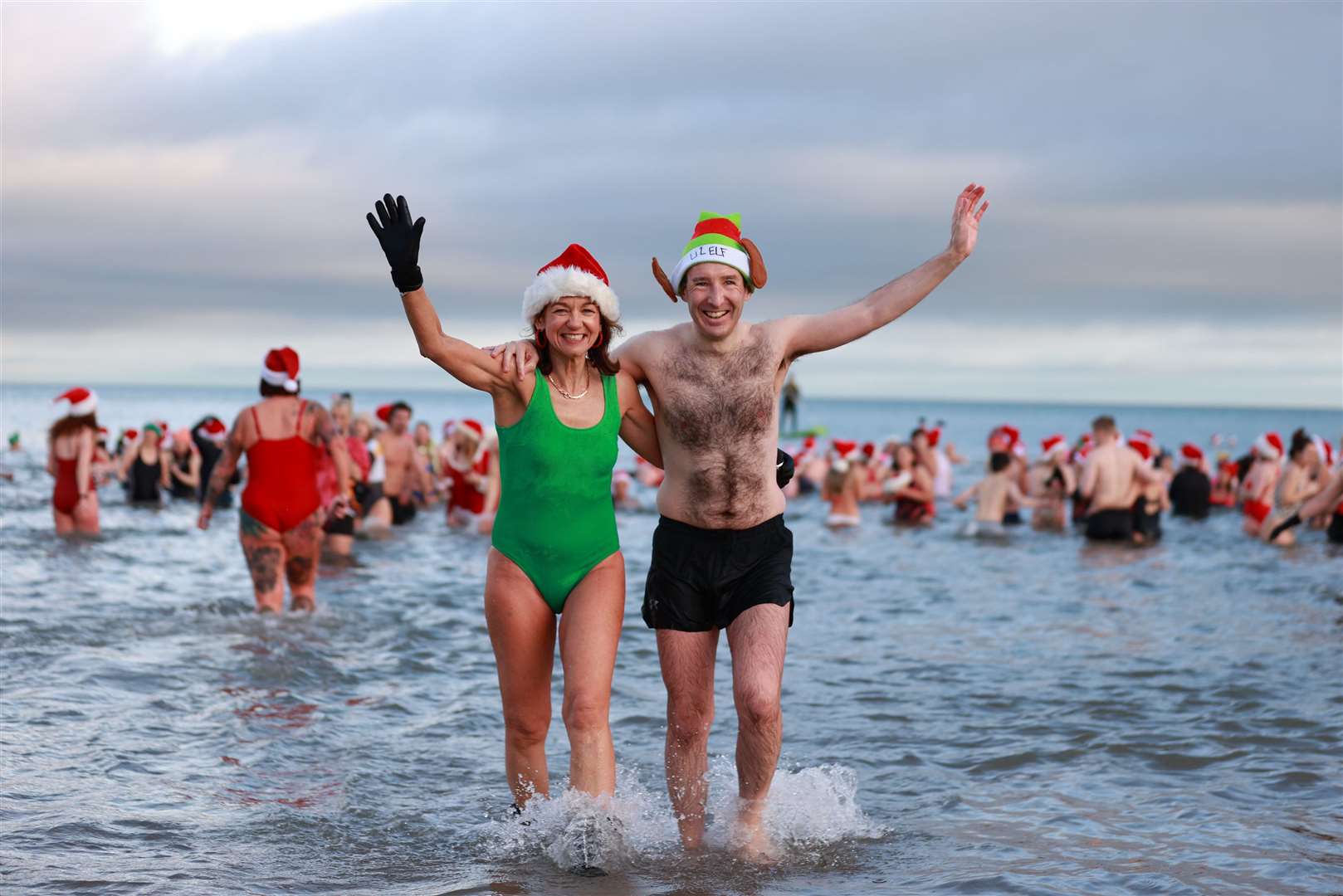 The Alliance Party’s Gillian McCollum and minister of agriculture, environment and rural affairs Andrew Muir take part in the annual Christmas Eve swim at Helen’s Bay (Liam McBurney/PA)