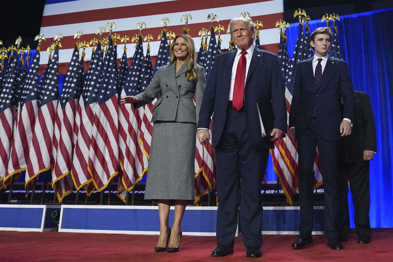 Donald Trump, Melania Trump and Barron Trump arrive to speaks at the election night party in Florida (Evan Vucci/AP)