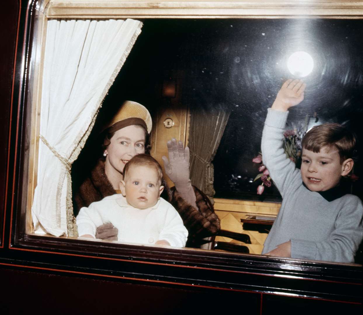 The Queen with Prince Edward and Prince Andrew at they leave for Sandringham on the Royal Train in 1964 (PA)