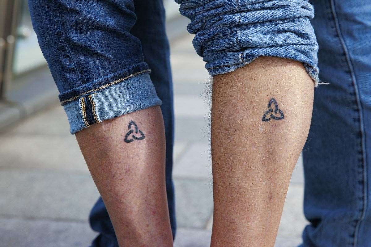 Angela Harsanyi and Gian Perroni show off their matching Trinity tattoos (Liam McBurney/PA)