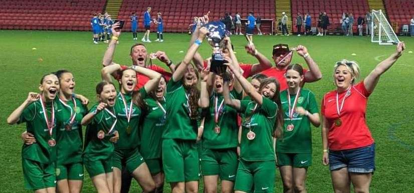 Lydd Grasshoppers under-13 girls' celebrate after winning this month's tournament at Charlton Athletic's Valley Stadium