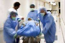 A patient being rushed through a hospital ward