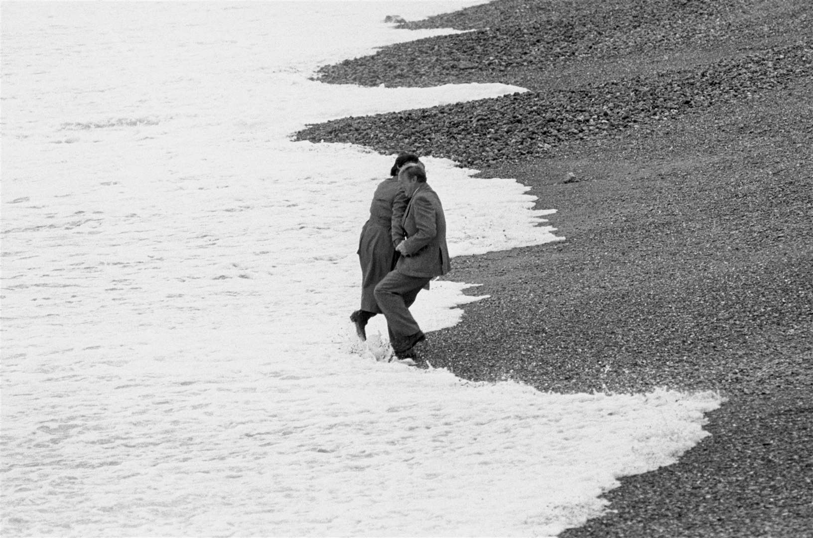 Labour leader Neil Kinnock and his wife Glenys, fooling around on Brighton beach (Archive/PA)