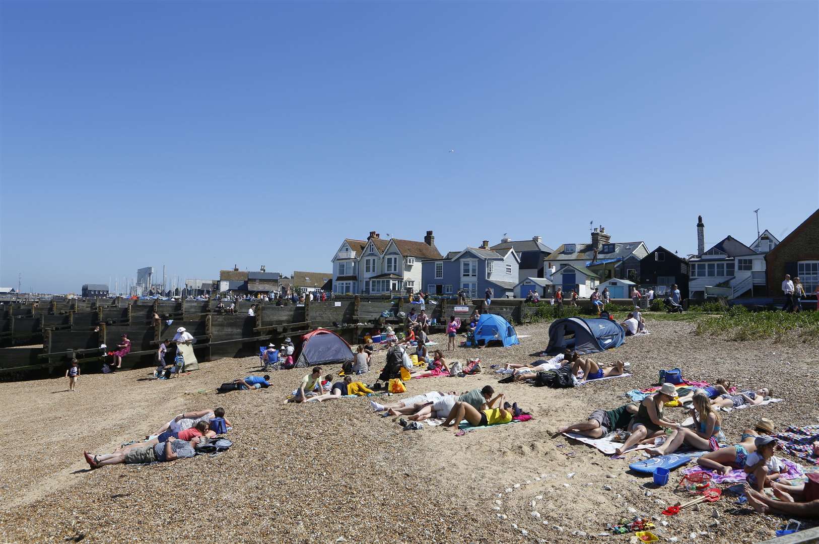 Beachgoers enjoying the sunshine in Whitstable