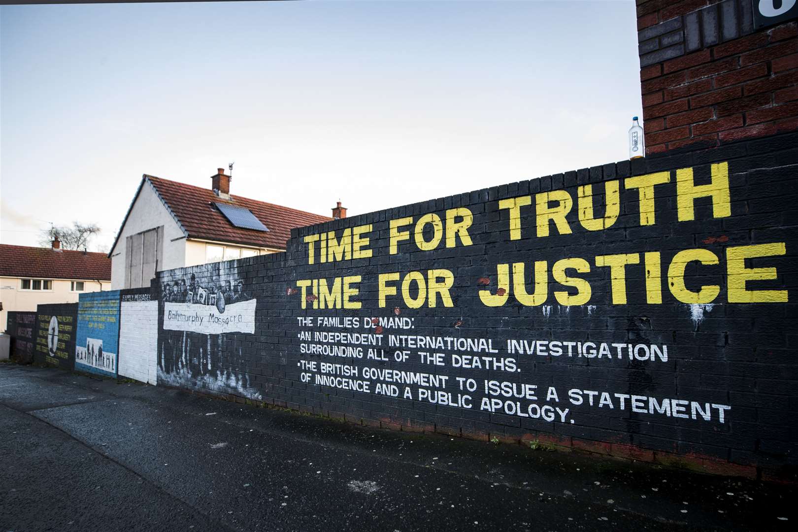 A mural on a wall in the Ballymurphy area of west Belfast where shooting of 10 civilians took place in 1971 (Liam McBurney/PA)