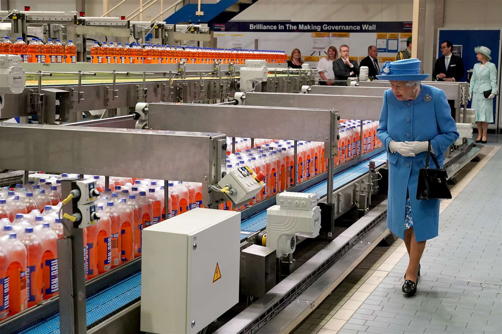 The Queen walks the factory floor during a visit to AG Barr’s plant in Cumbernauld (Andrew Milligan/PA)