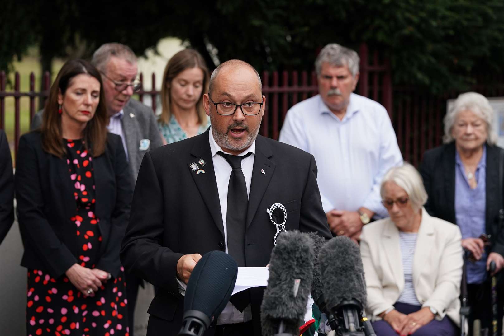 Stuart Stephens, the father of Olly Stephens, reads a statement outside Reading Crown Court beside his mother Amanda (Steve Parsons/PA)