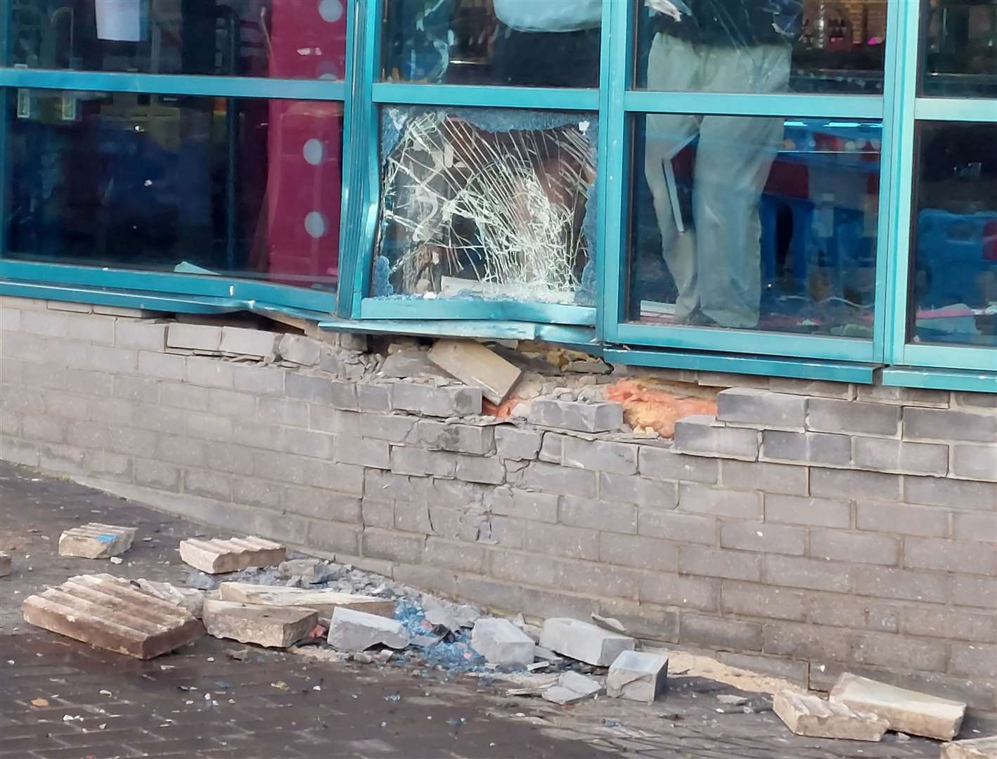 Staff assessing the damage to Hollywood Bowl in Ashford