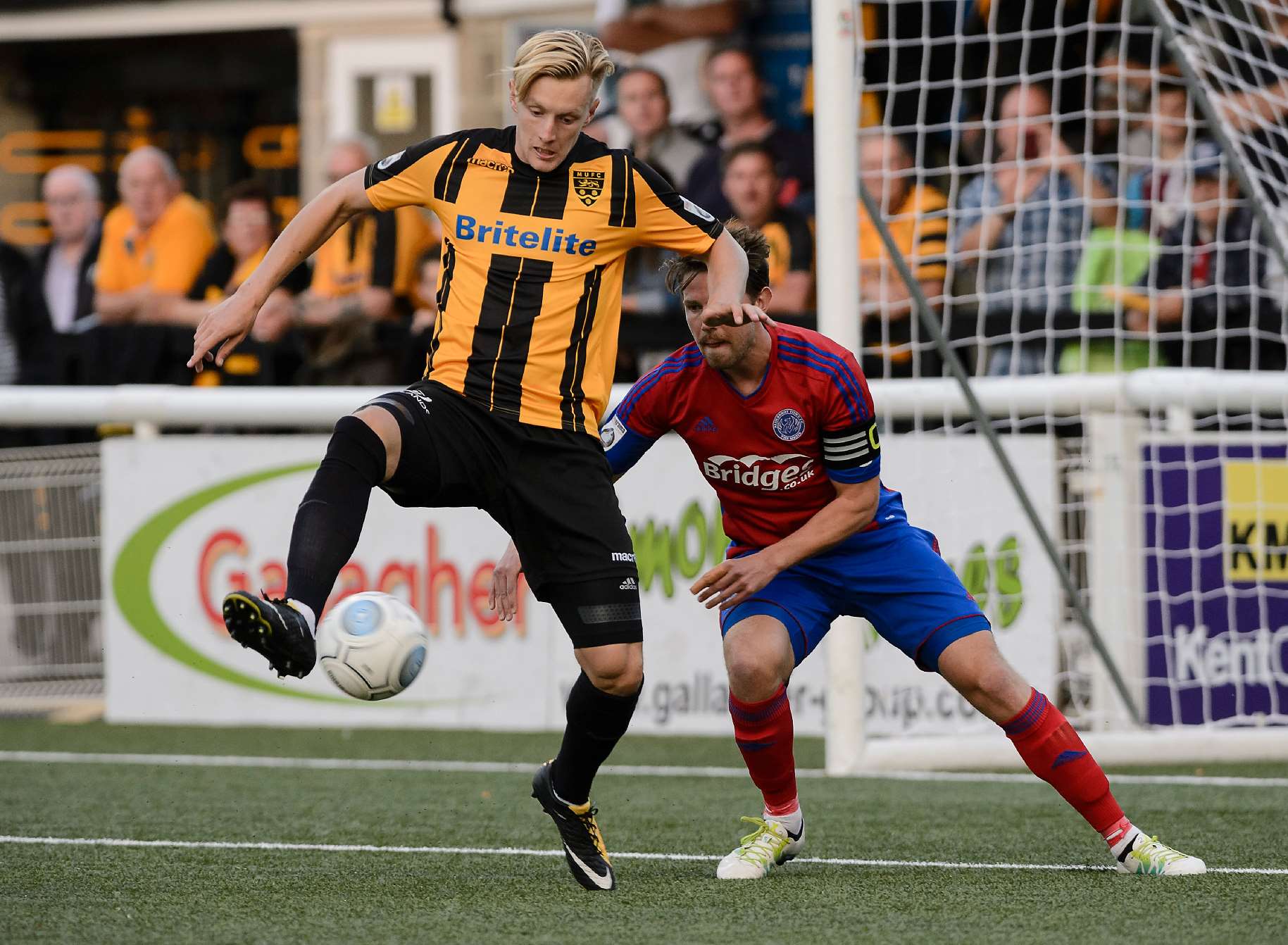 Joe Pigott keeps Aldershot captain Callum Reynolds at bay Picture: Andy Payton