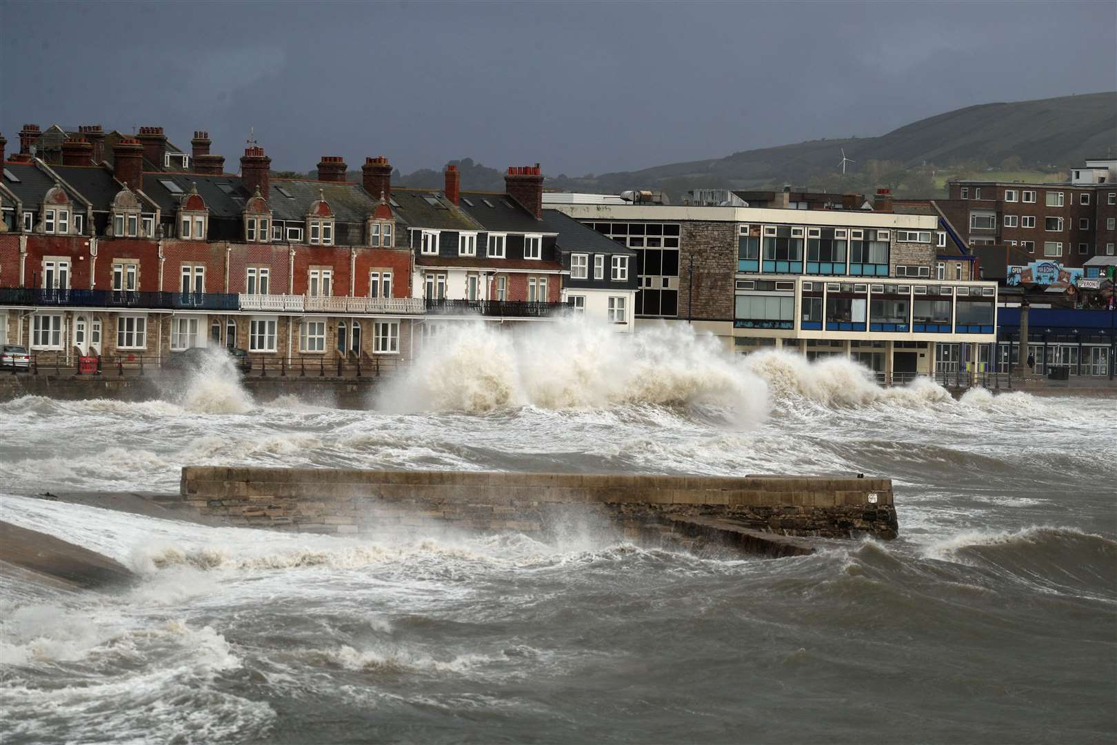 Waves crash along the coast at Swanage in Dorset (Steve Parsons/PA)