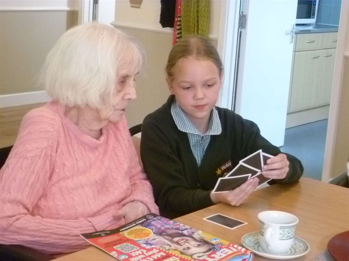 Freya with a resident at the care home (Joanne Bardgett/PA)