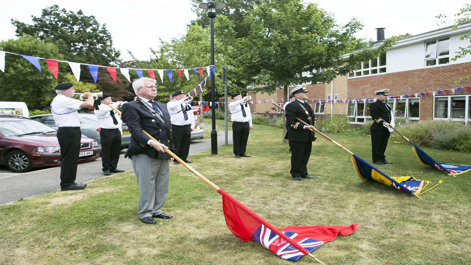 Lowering the standard with members of TS Brilliant during the service at Rusthall Lodge