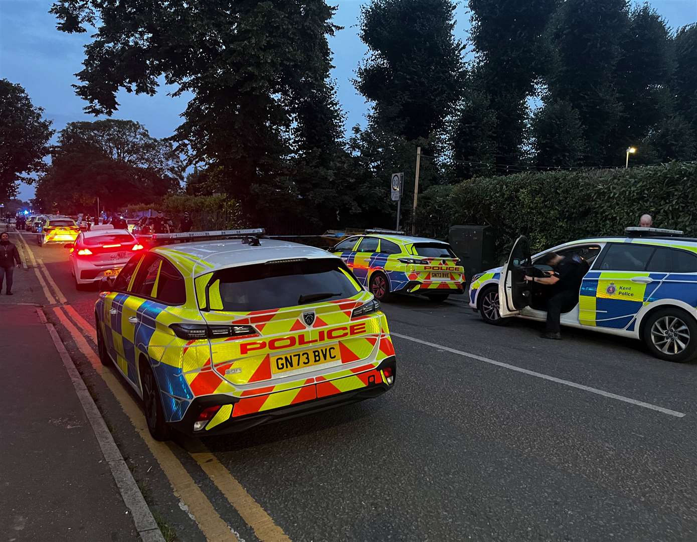 Police cars line the street in Gravesend