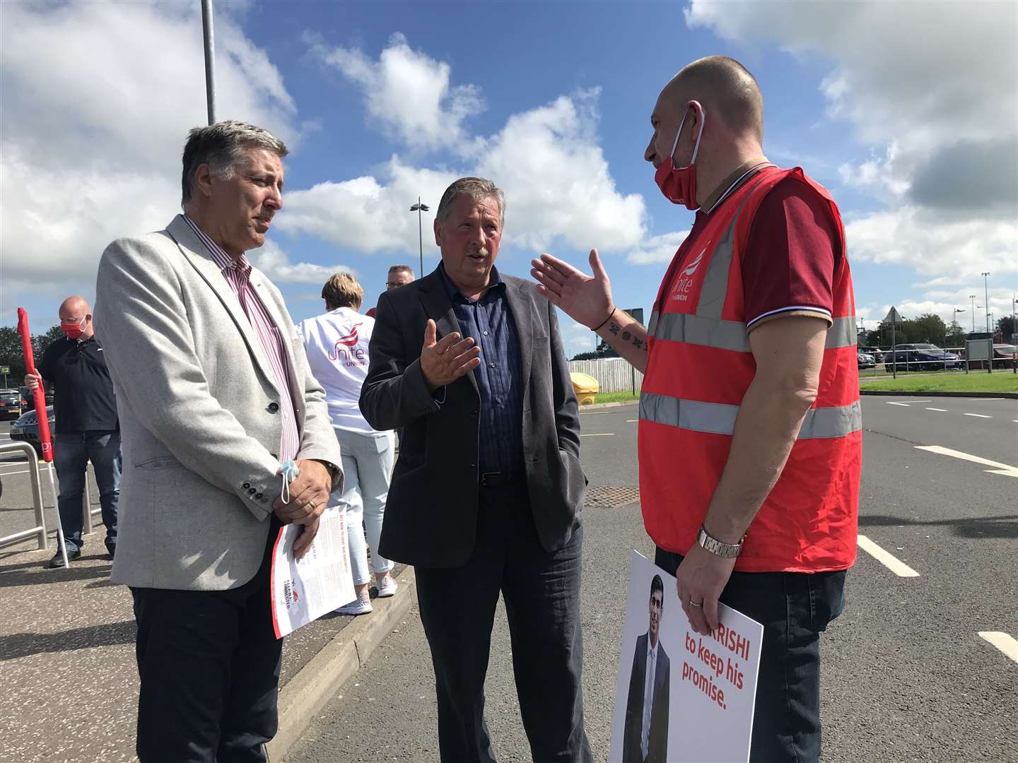 South Antrim MP Paul Girvan and East Antrim MP Sammy Wilson talk to George Brash (right) of Unite the Union. (Rebecca Black/PA)