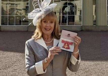 Jo James collects her OBE at the palace