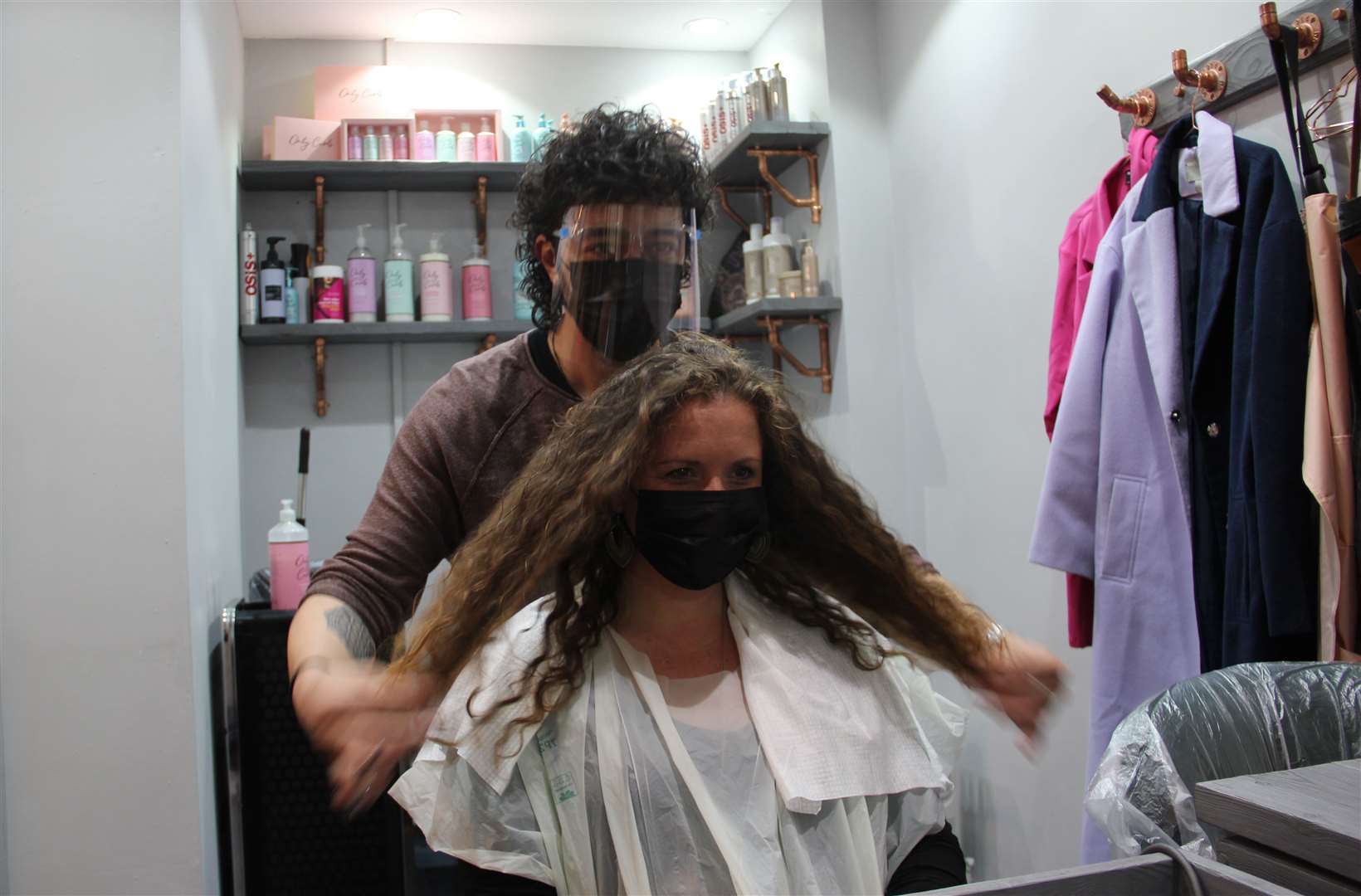 Stylist Danny Law with customer Amy Smith, who is visiting a hairdresser for the first time in more than a year, at the Strand & Lock salon in Birmingham (Richard Vernalls/PA)