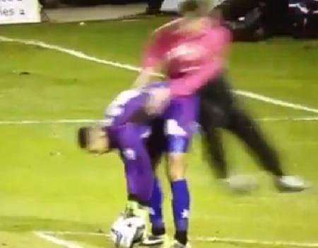 A Gills fan jumps on Wycombe goalkeeper Jordan Archer at Priestfield