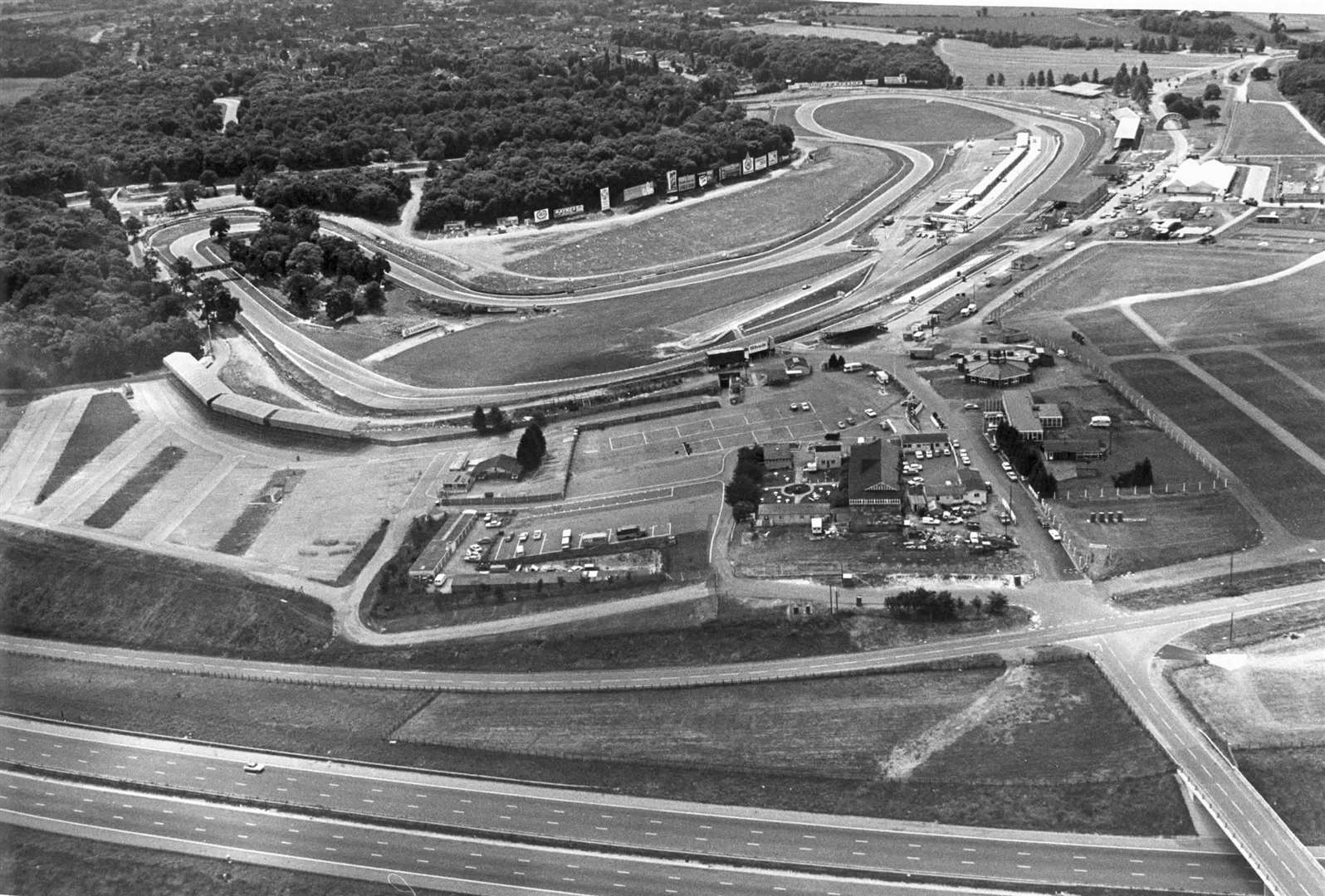 Just a single car can be seen on the M20 in this photo of the much-loved Brands Hatch race circuit in August 1978. Part of the demanding Grand Prix loop can be picked out amongst the trees in the top left of the shot
