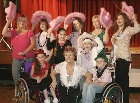 HELPING HAND: Alecia Yarlett, eight, and George Kieith, 10, with some of the women who were line dancing on their behalf. Picture: PETER STILL