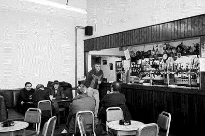 A former miner props up the bar in the Snowdown Working Men's Club in 1993.