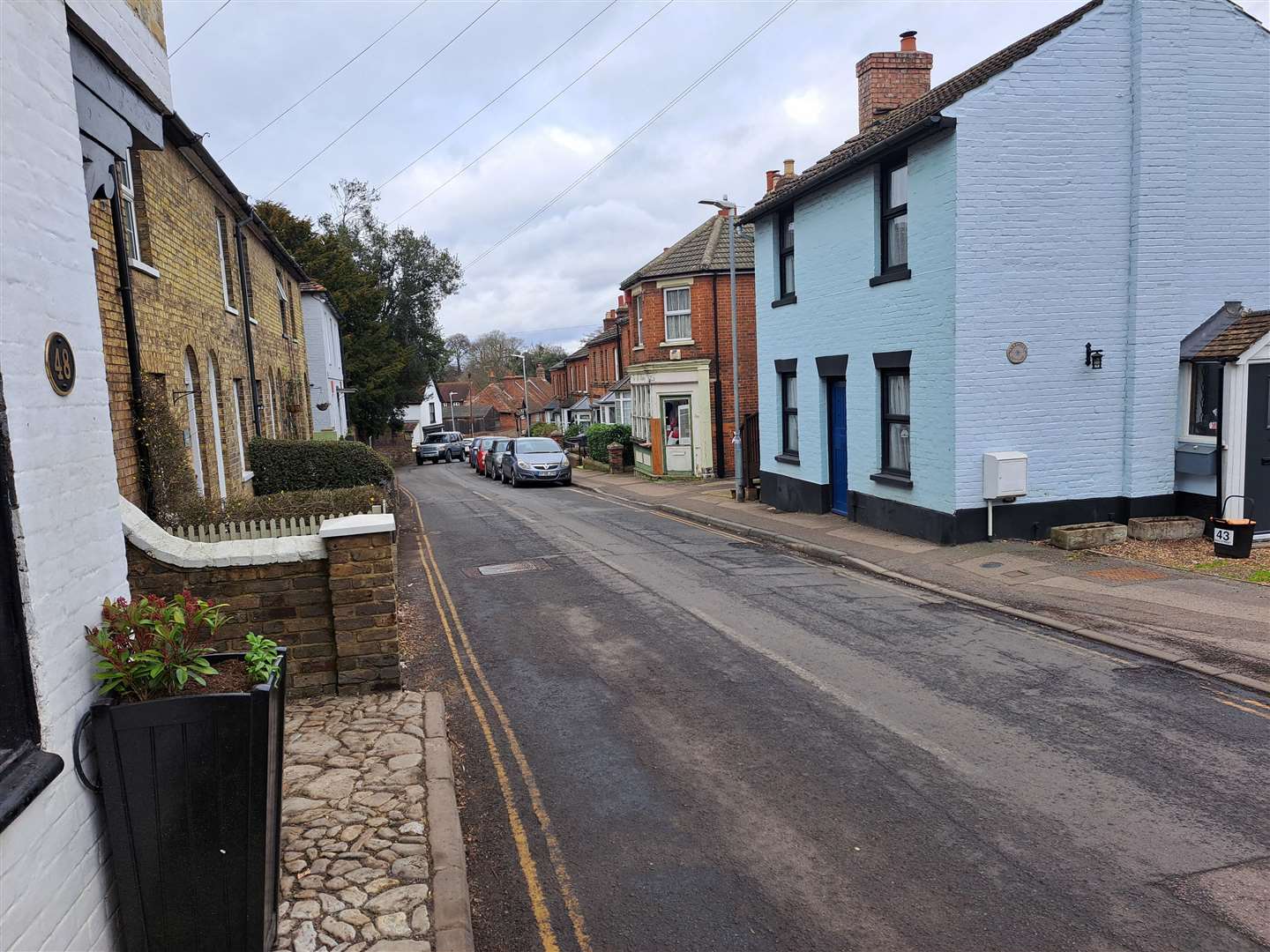 Residents say their parked vehicles act as a welcome traffic-calming measure