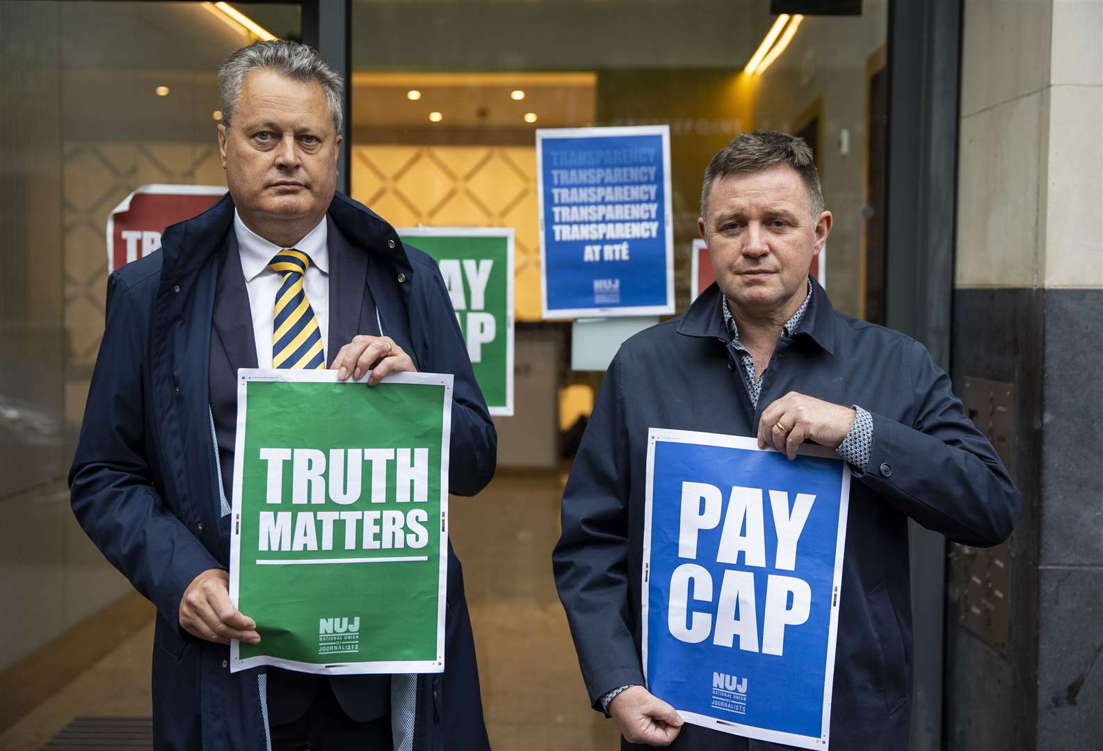 RTE National Union of Journalists members Vincent Kearney (left) and Conor Macauley outside the RTE studio in Belfast (PA/Liam McBurney)