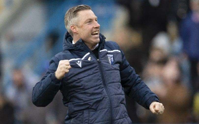 Gillingham manager Neil Harris enjoys a post-match celebration with the supporters.