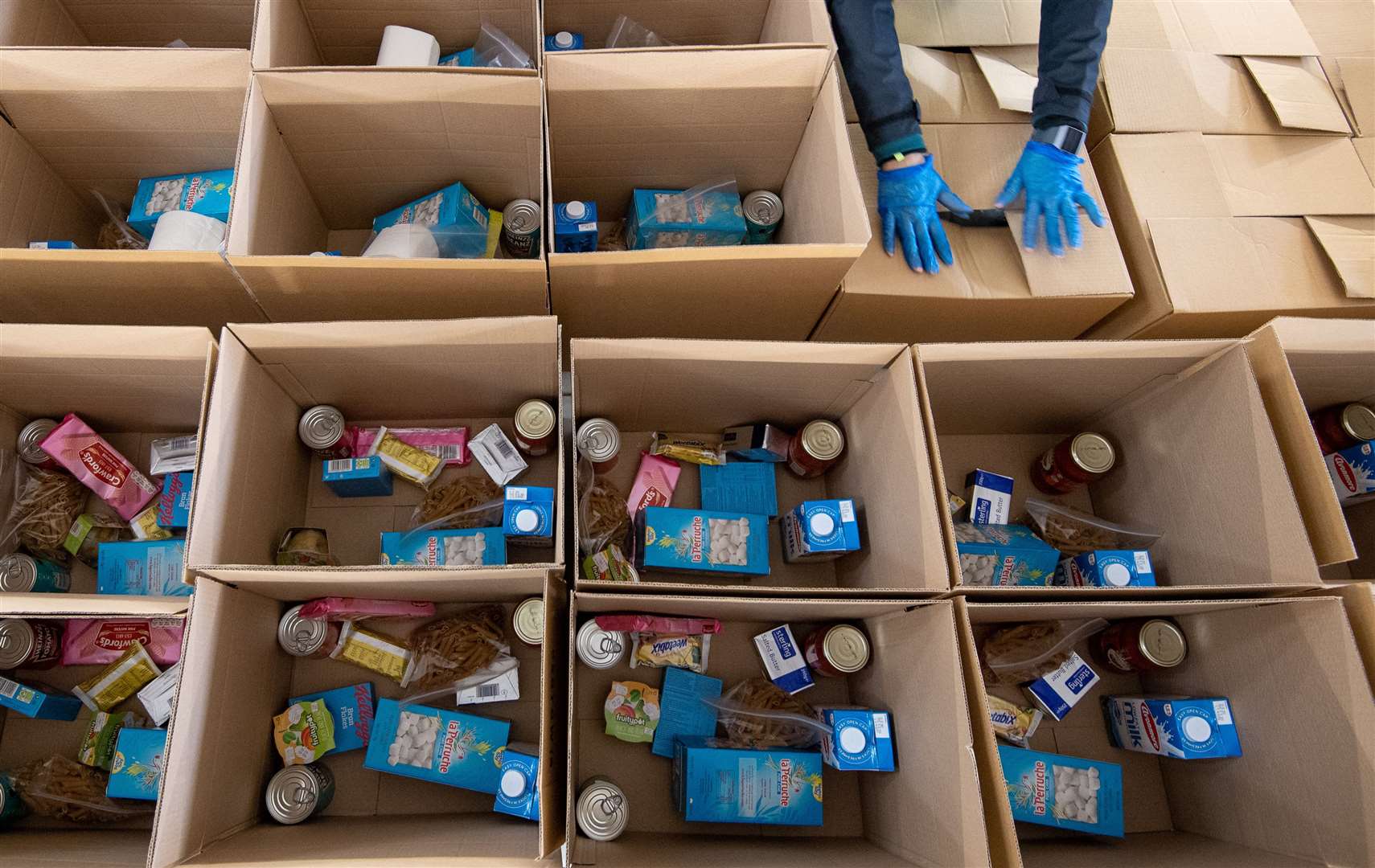 With thousands of people told to shield and not venture outdoors at all, and huge numbers enduring financial hardship caused by the virus, food parcels were a lifeline for many (Joe Giddens/PA)