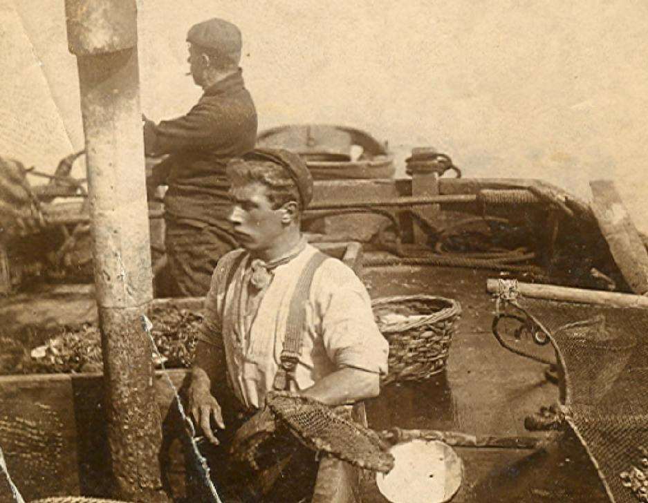 This is Harry Blake Hill aboard his bawley during a fishing trip in 1905. His crew mate in the stern has not been identified (5589246)