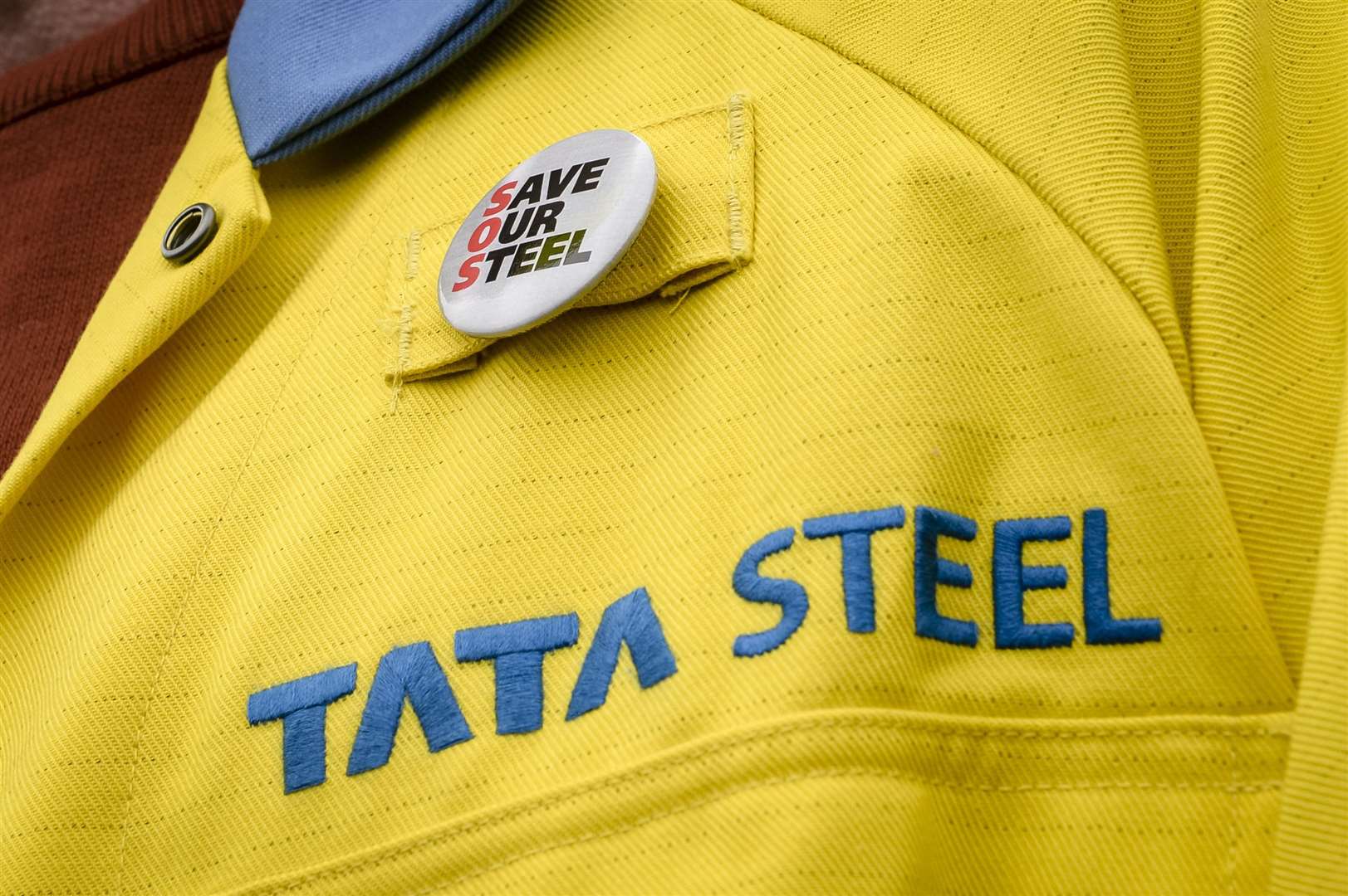 A steel worker wearing a badge on his jacket outside the UK’s largest steel works in Port Talbot, South Wales (Ben Birchall/PA)