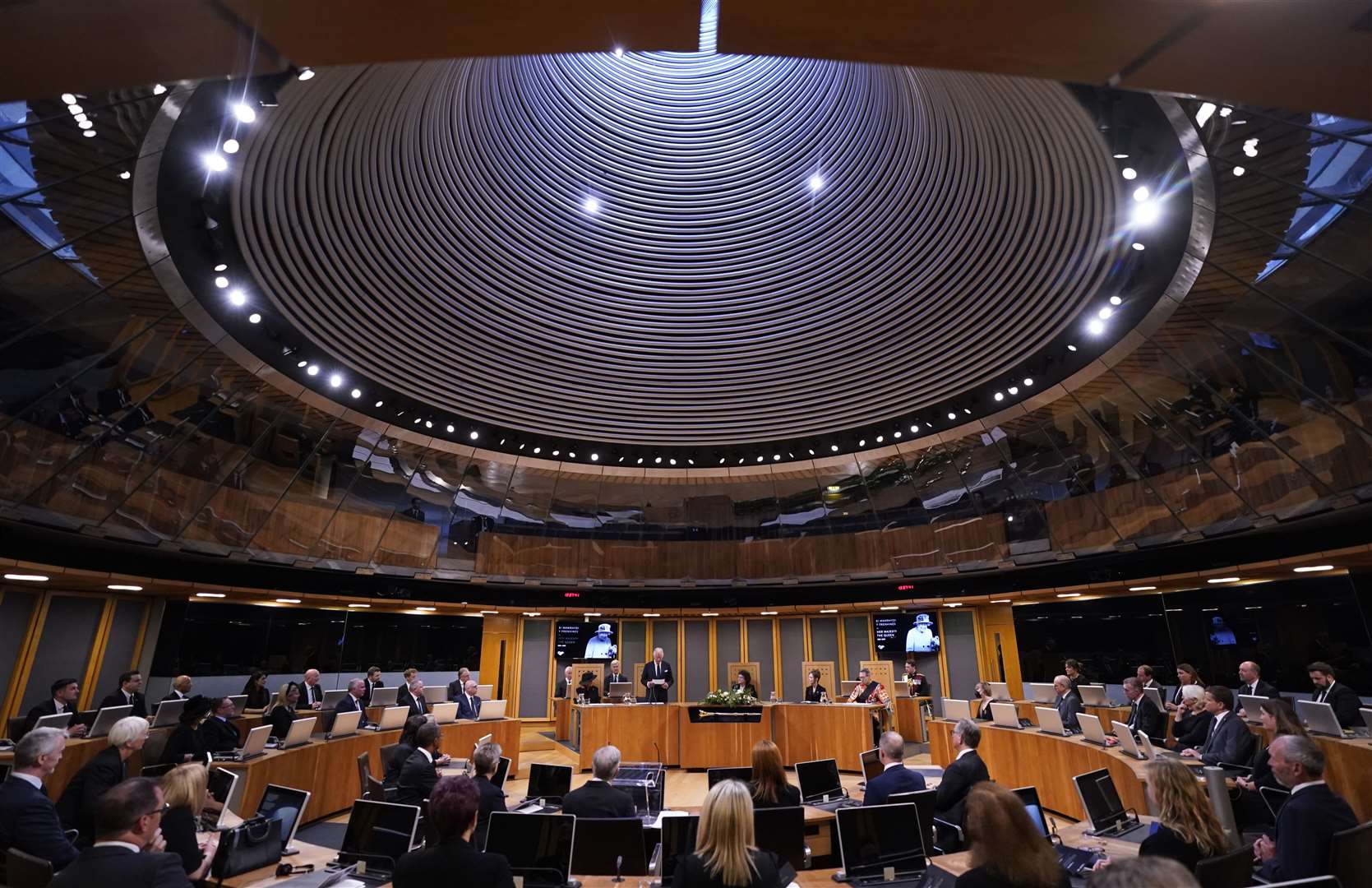 The King, with the Queen Consort, speaking after receiving a Motion of Condolence at the Senedd in Cardiff (Andrew Matthews/PA)