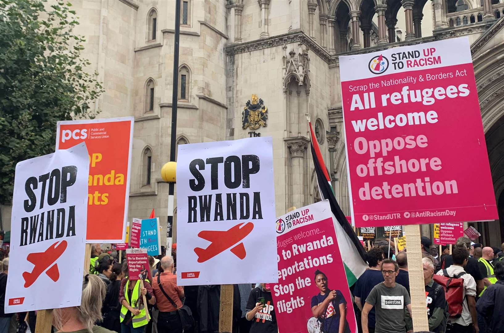 Demonstrators outside the Royal Courts of Justice, central London, protesting against the Government’s plan to send some asylum seekers to Rwanda, which the High Court has now ruled as lawful (PA)