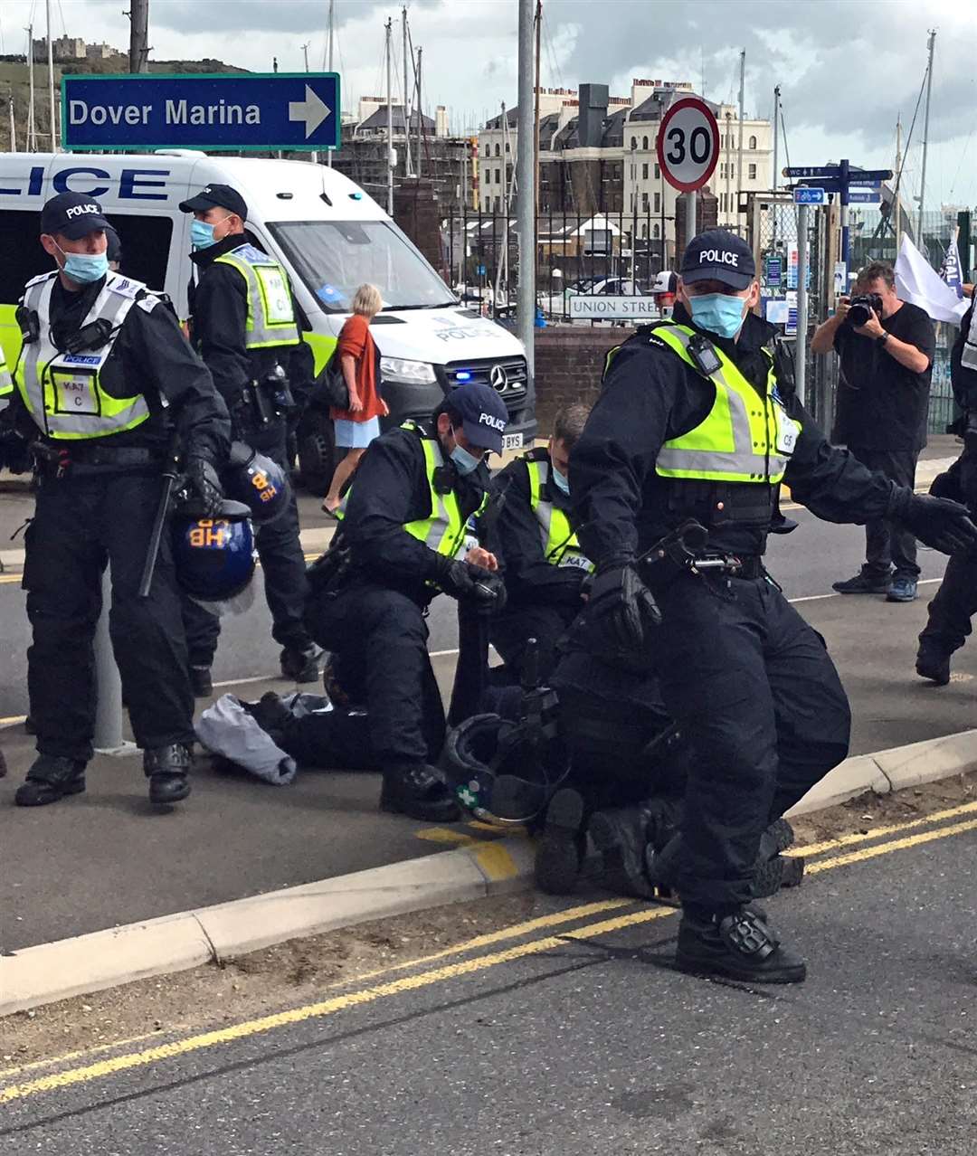 A man is restrained by police (Michael Drummond/PA)