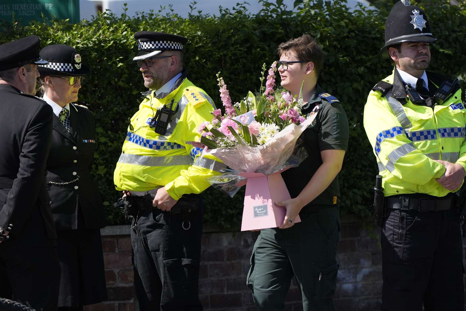 A paramedic carries flowers ahead of the funeral of Southport stabbing victim Alice da Silva Aguiar (Danny Lawson/PA)