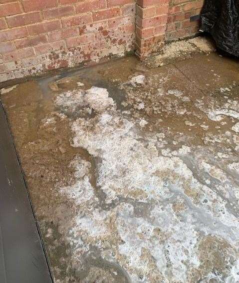 The overflowing manhole cover at the family's home