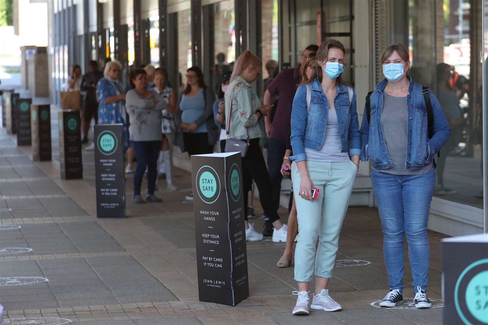 Shoppers in line outside John Lewis in Kingston (Steve Parsons/PA)