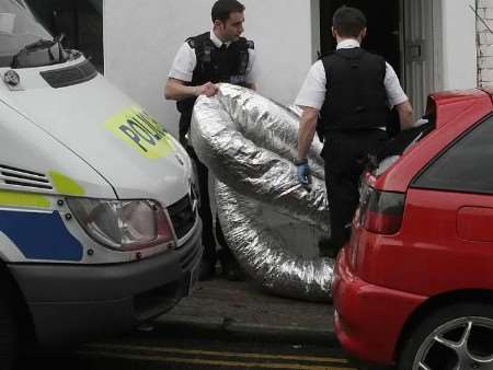 Police officers removing materials from the property at the weekend. Picture: PETER STILL