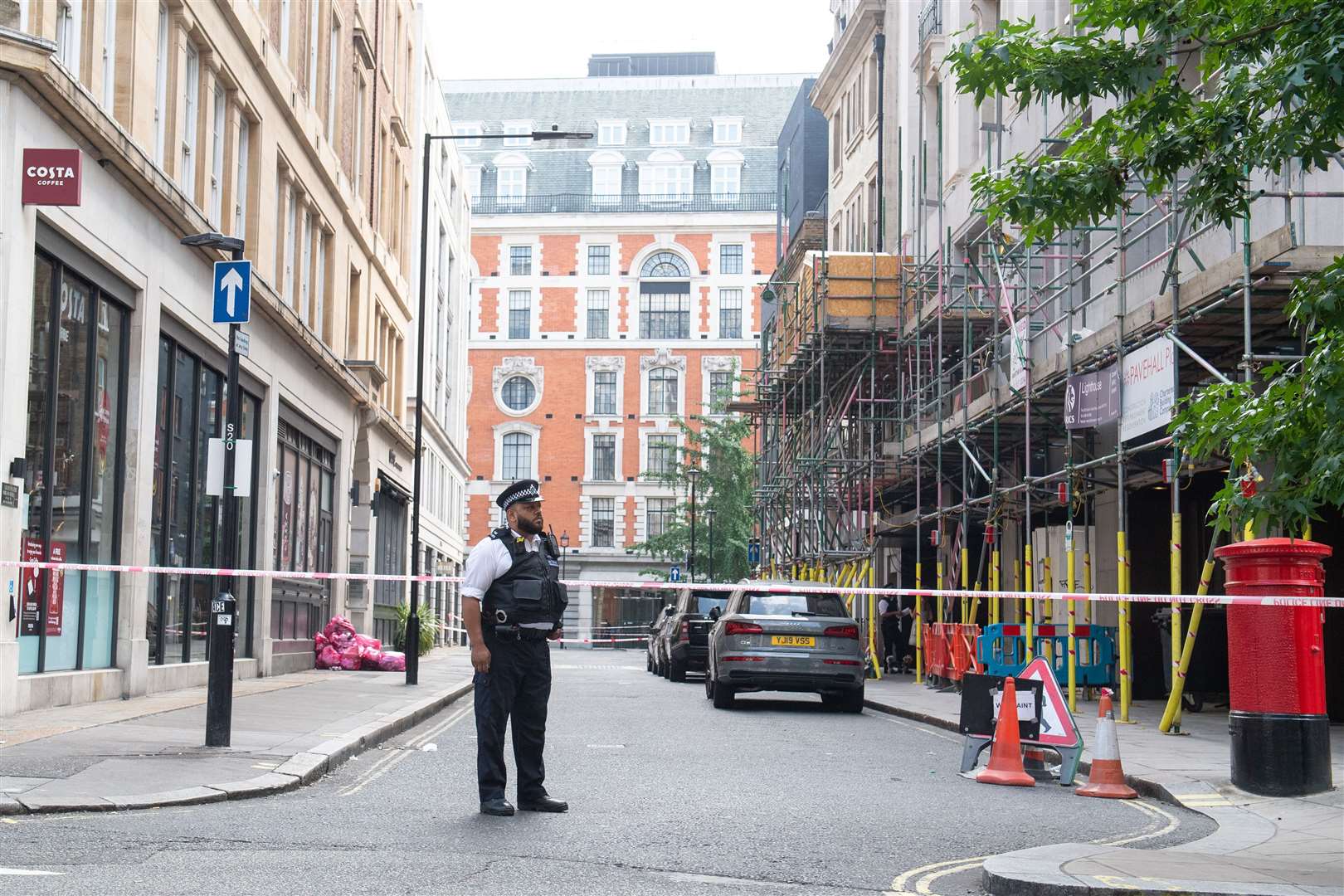 Police at a cordon on Market Place, off Oxford Street (Dominic Lipinski/PA)